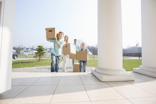 Professional house movers unloading belongings at a new home