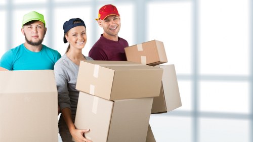 Moving team loading boxes into a van in Ilford