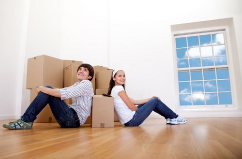 Boxes, sofas, and home items being loaded for a house removal